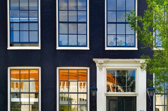 building, home, house, brick, painted brick, facade, architecture, residential, amsterdam, netherlands, holland, europe, blue home, blue house, blue painting, blue paint. What Painting a Brick House Costs per Square Foot